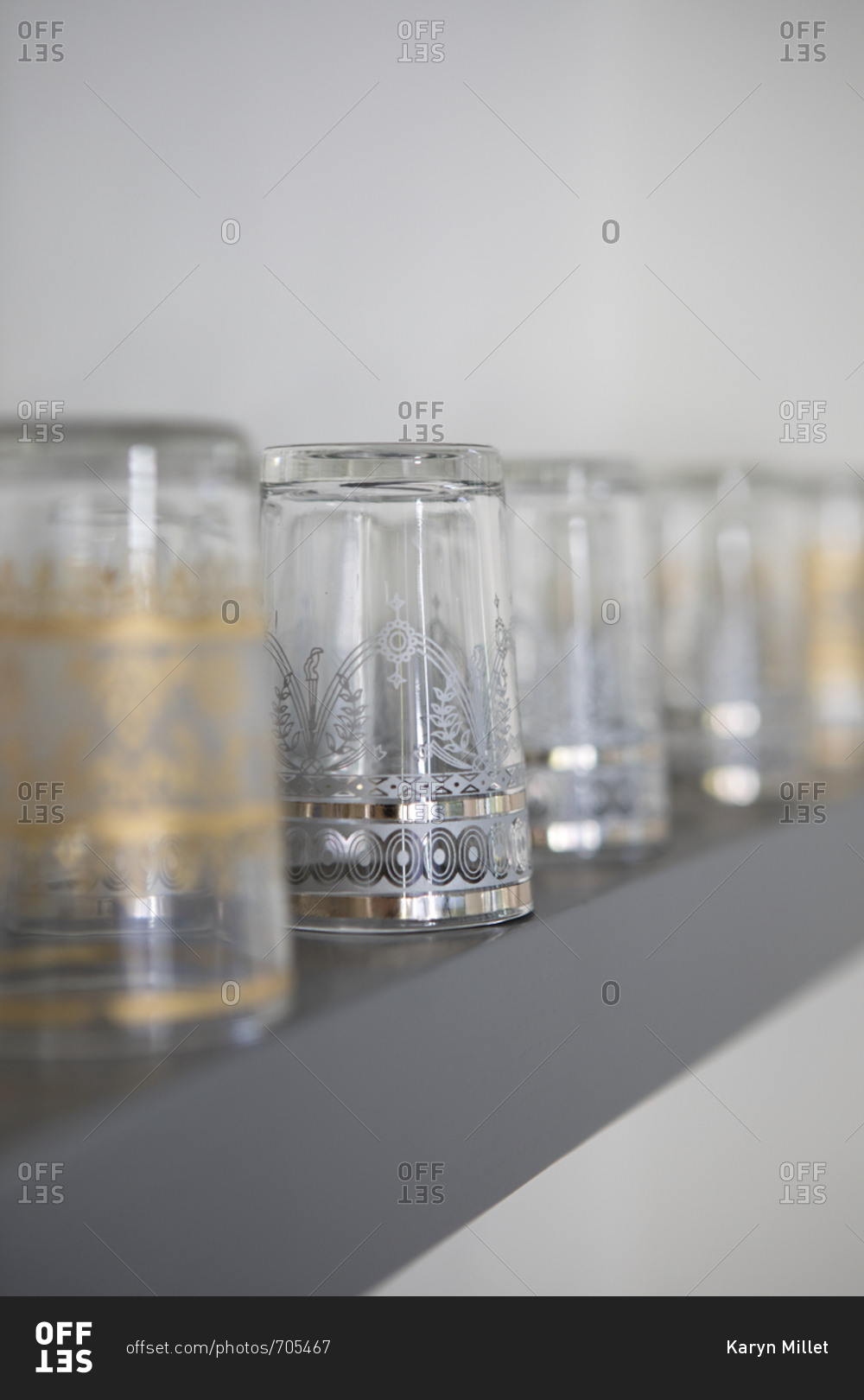 Decorative glasses stored upside down on shelf stock photo OFFSET