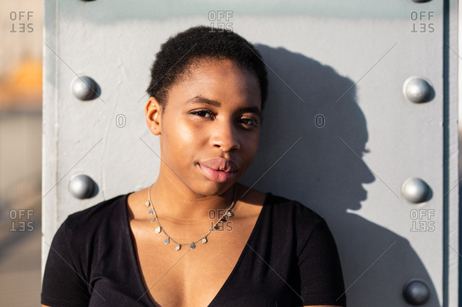 Portrait of young woman against wall