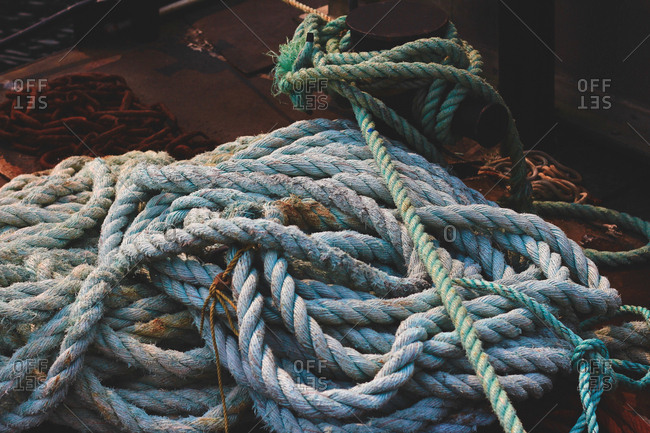 Piles of rope lying on deck of ship