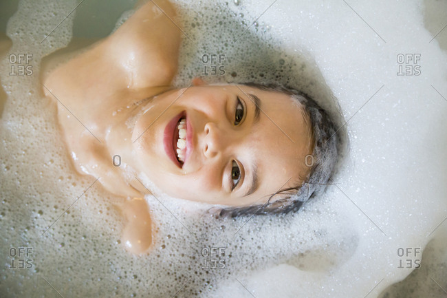 Portrait Of Happy Little Girl Bathing In A Tub Stock Photo