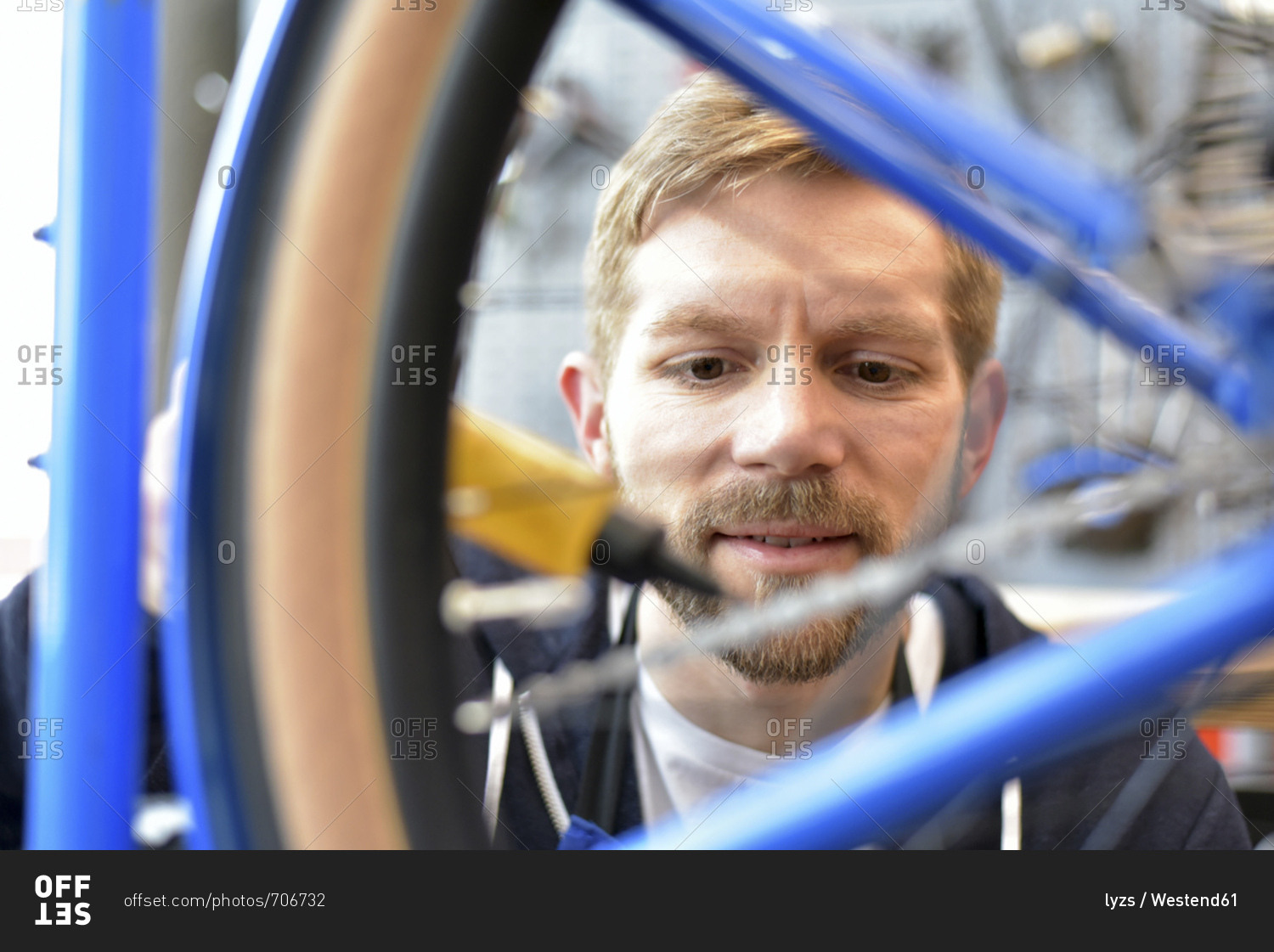 Bicycle mechanic lubricating bicycle chain