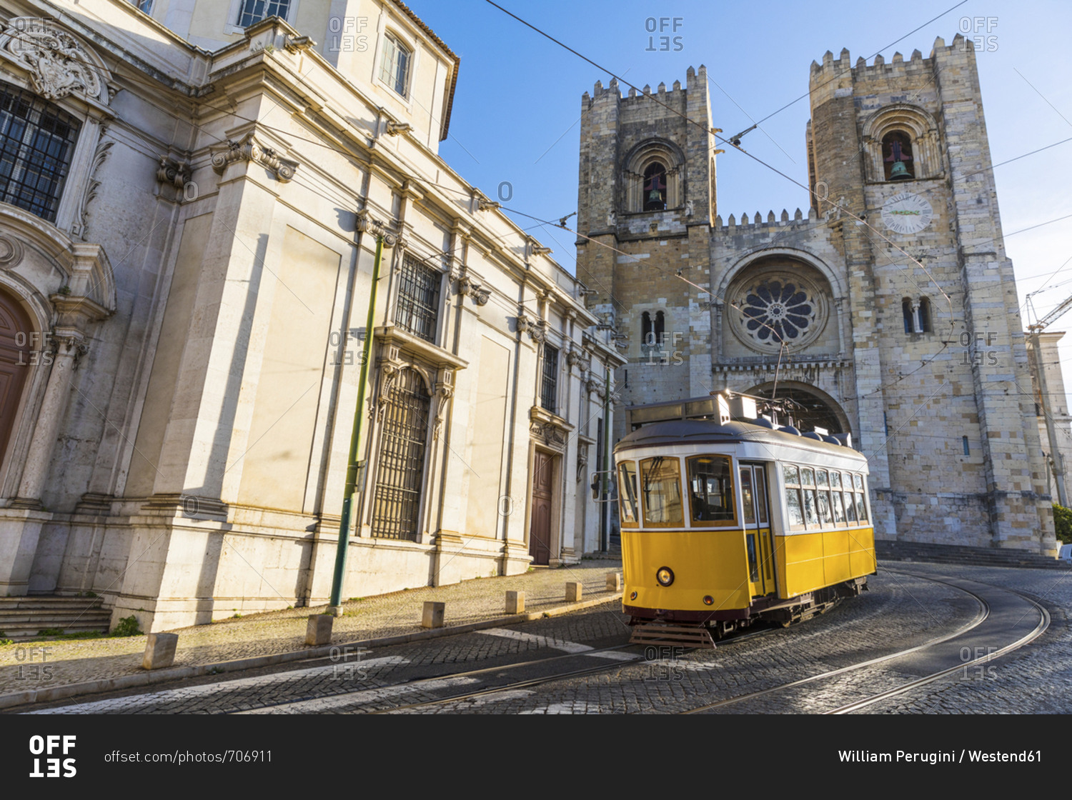 Portugal- Lisbon- typical yellow tram in front of the Cathedral