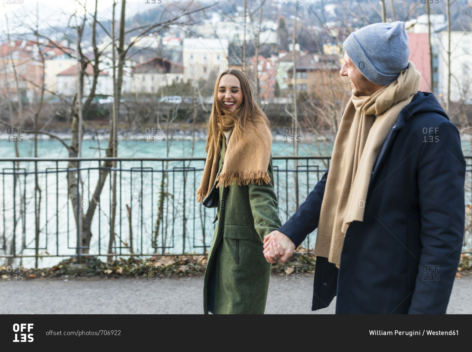 Austria- Innsbruck- happy young couple strolling together hand in hand at winter time