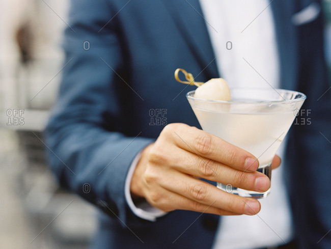 Man holding orange cocktail - Offset