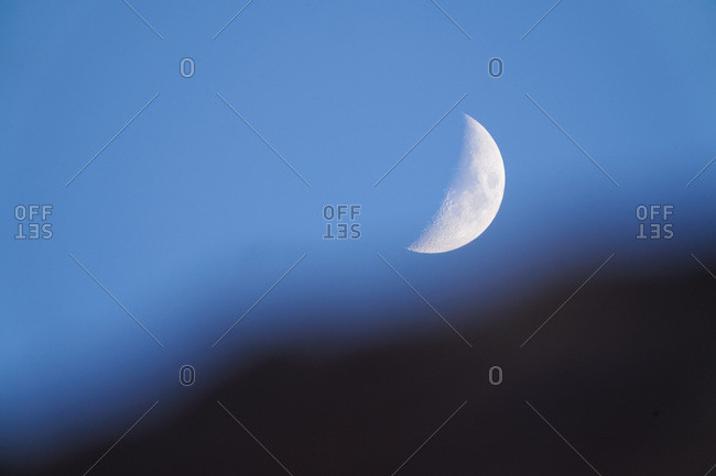 Half moon in blue sky