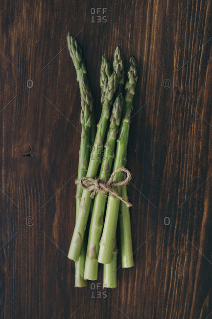 Asparagus on a wood table tied with twine