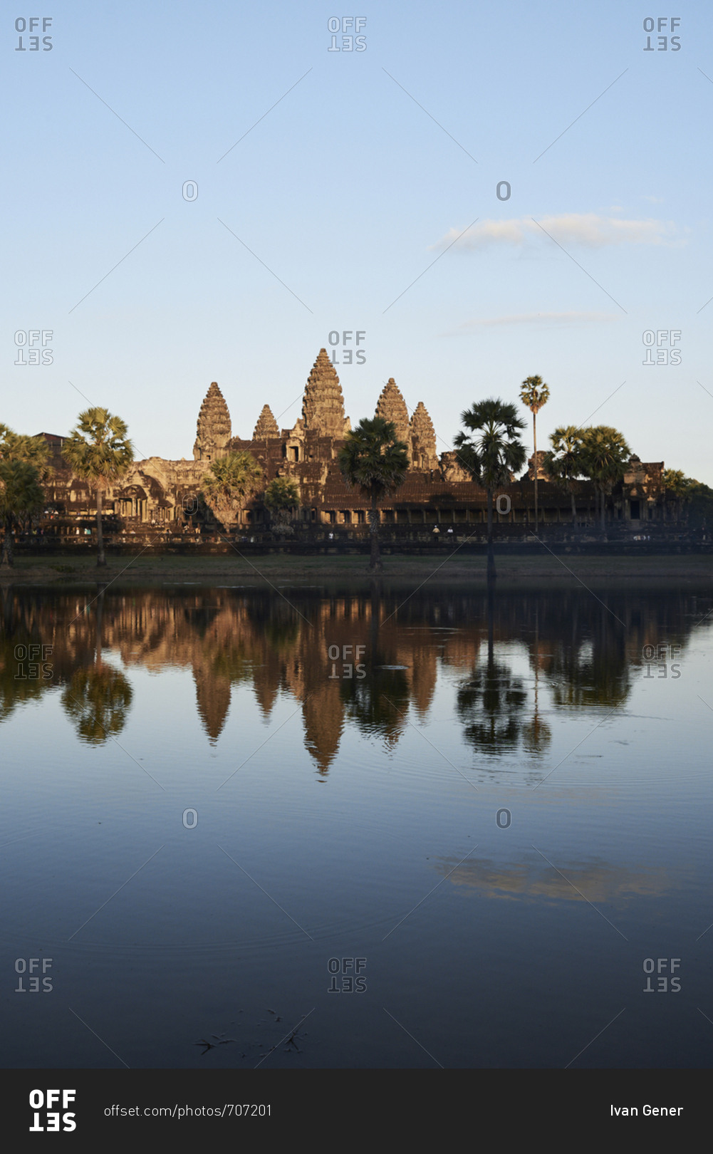 Cambodian landmark Angkor Wat temple with reflection in water at sunset, Siem Reap, Cambodia