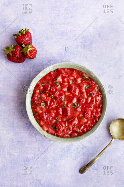 Ceramic bowl of strawberry basil jelly from above