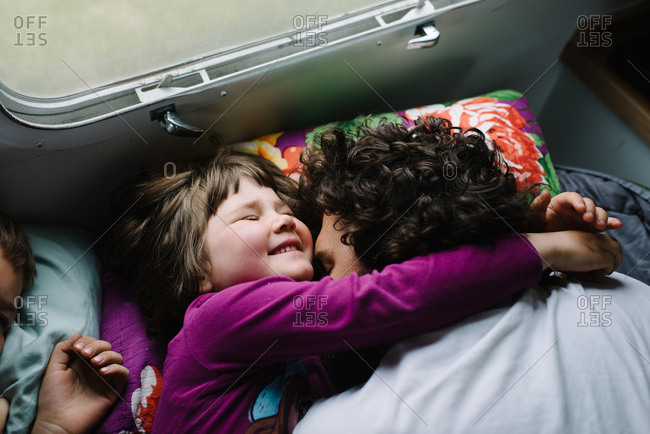 Girl hugging dad in camper bed
