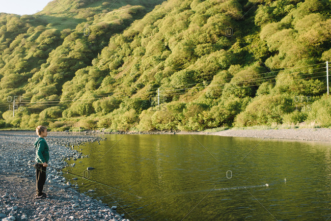 Boy fishing on an Alaskan river