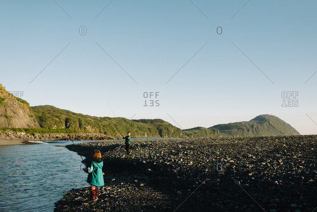 Two kids fishing on an Alaskan river