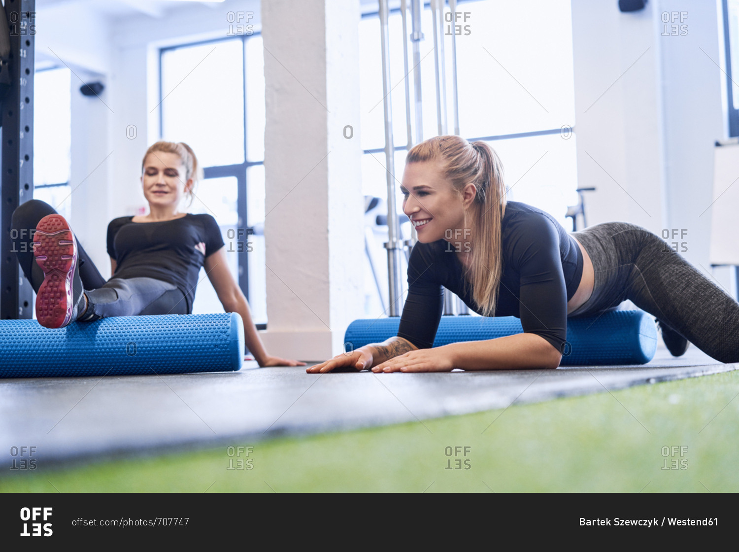 Two women massaging after gym workout