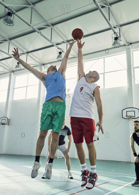 Men playing basketball- defense