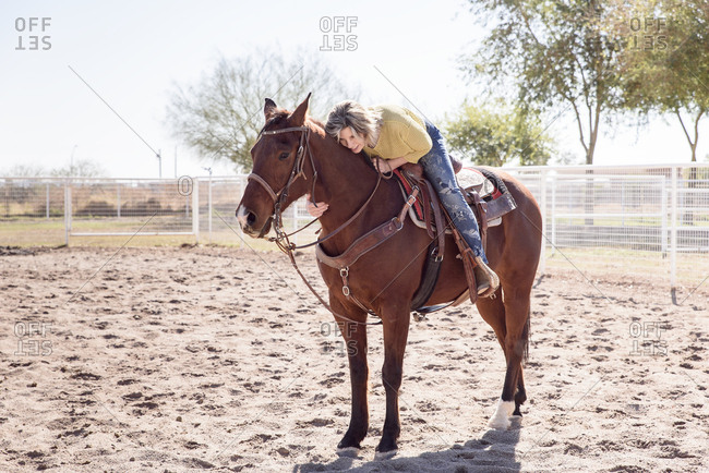 Woman hugging horse