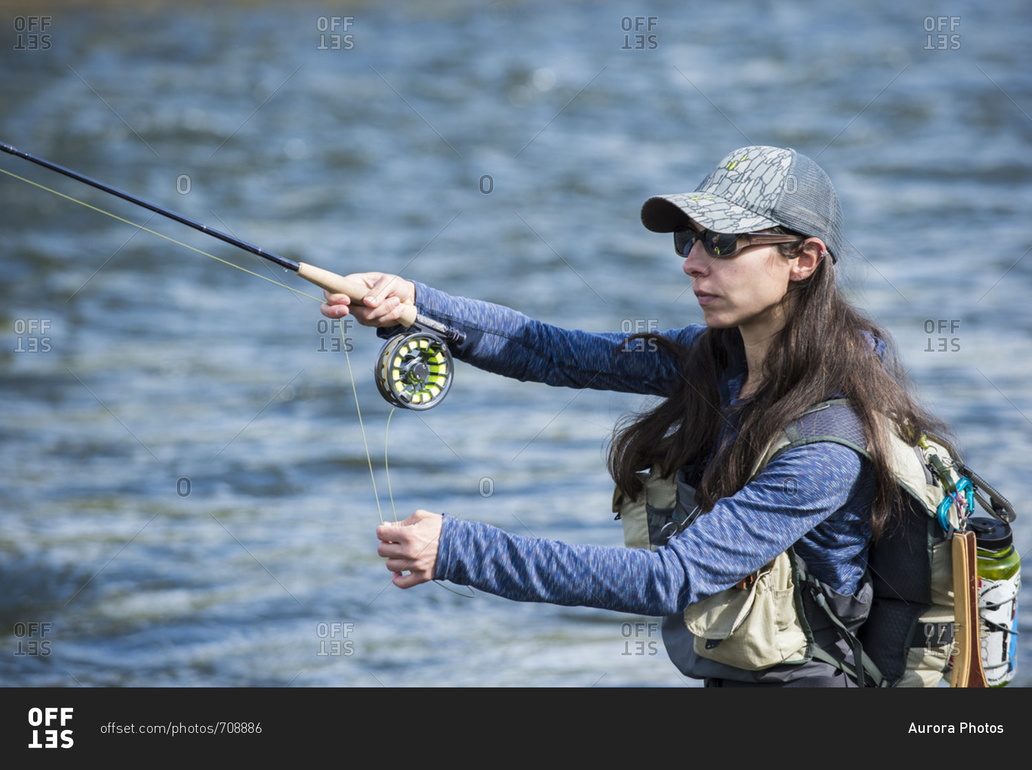 Woman fishing in river, Colorado, USA