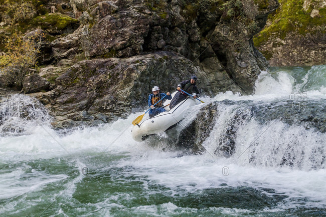 Two men rafting down waterfall on Little North Santiam River, Opal Creek Wilderness, Oregon, USA