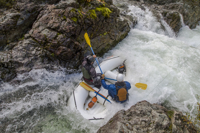 Whitewater rafters dropping into Thors Playroom rapid on section of upper Little North Santiam River in Opal Creek Wilderness, Oregon, USA