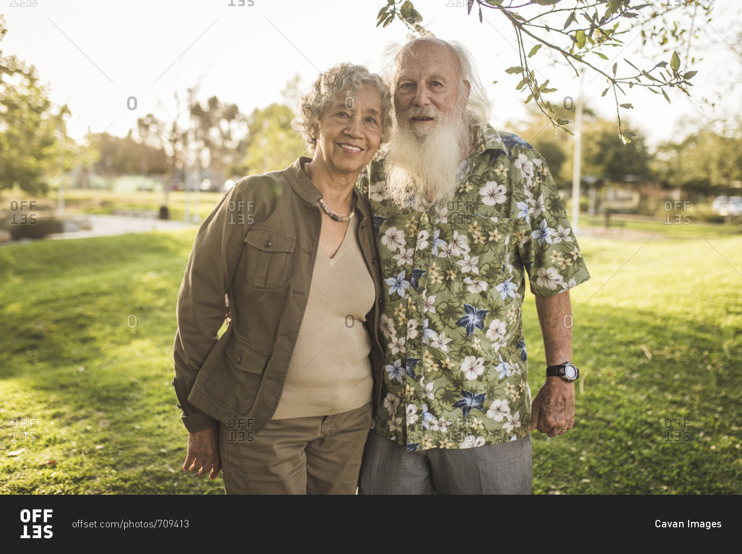 Portrait of confident senior couple standing at park