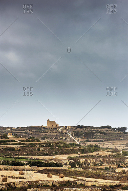 Lone church building across rolling farmlands