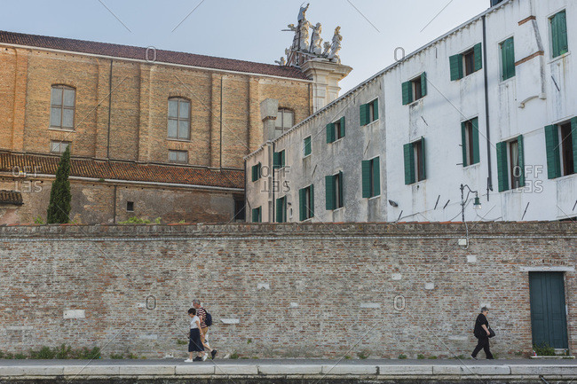 Venice, Italy - May 11, 2018: Tourist walking along Fondamente Nove near Chiesa de Gesuit