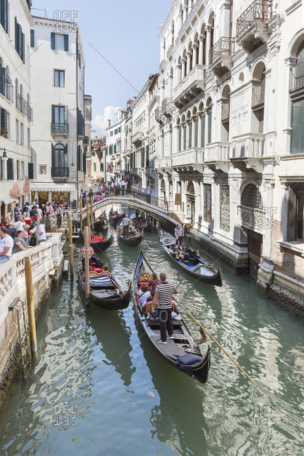 Venice, Italy - May 12, 2018: Tourist-crowded canals and sidewalk