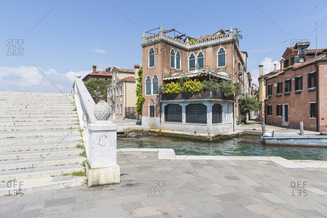 Venice, Italy - May 13, 2018: Lush Porch on old house next to staired-bridge on Riva di Sette Martiri