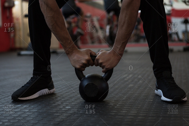 Athlete exercising with kettlebell in gym