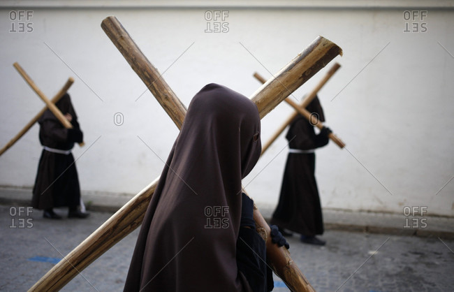 April 14, 2017: Hooded penitents carry crosses during Easter Week celebrations in Baeza, Jaen Province, Andalusia, Spain