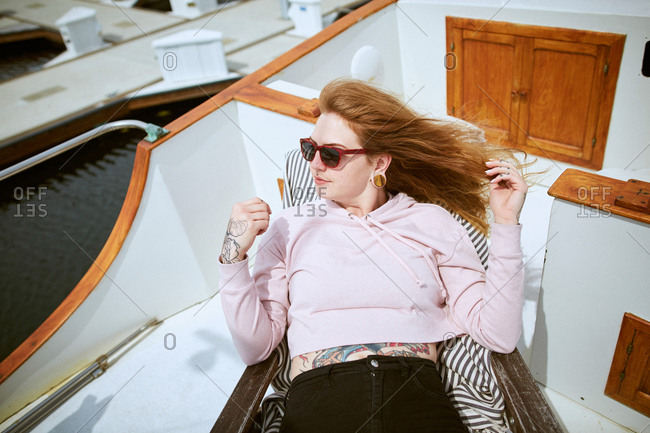 Young woman relaxing on boat and looking to side