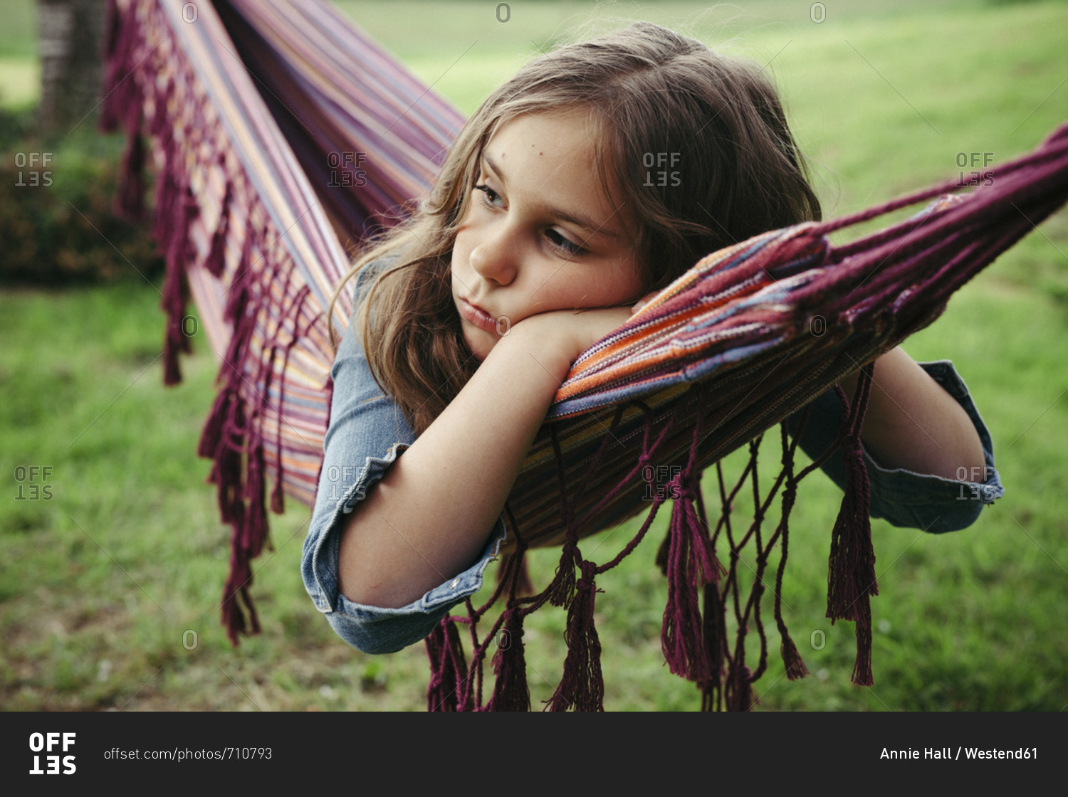 Portrait of sad girl lying in hammock