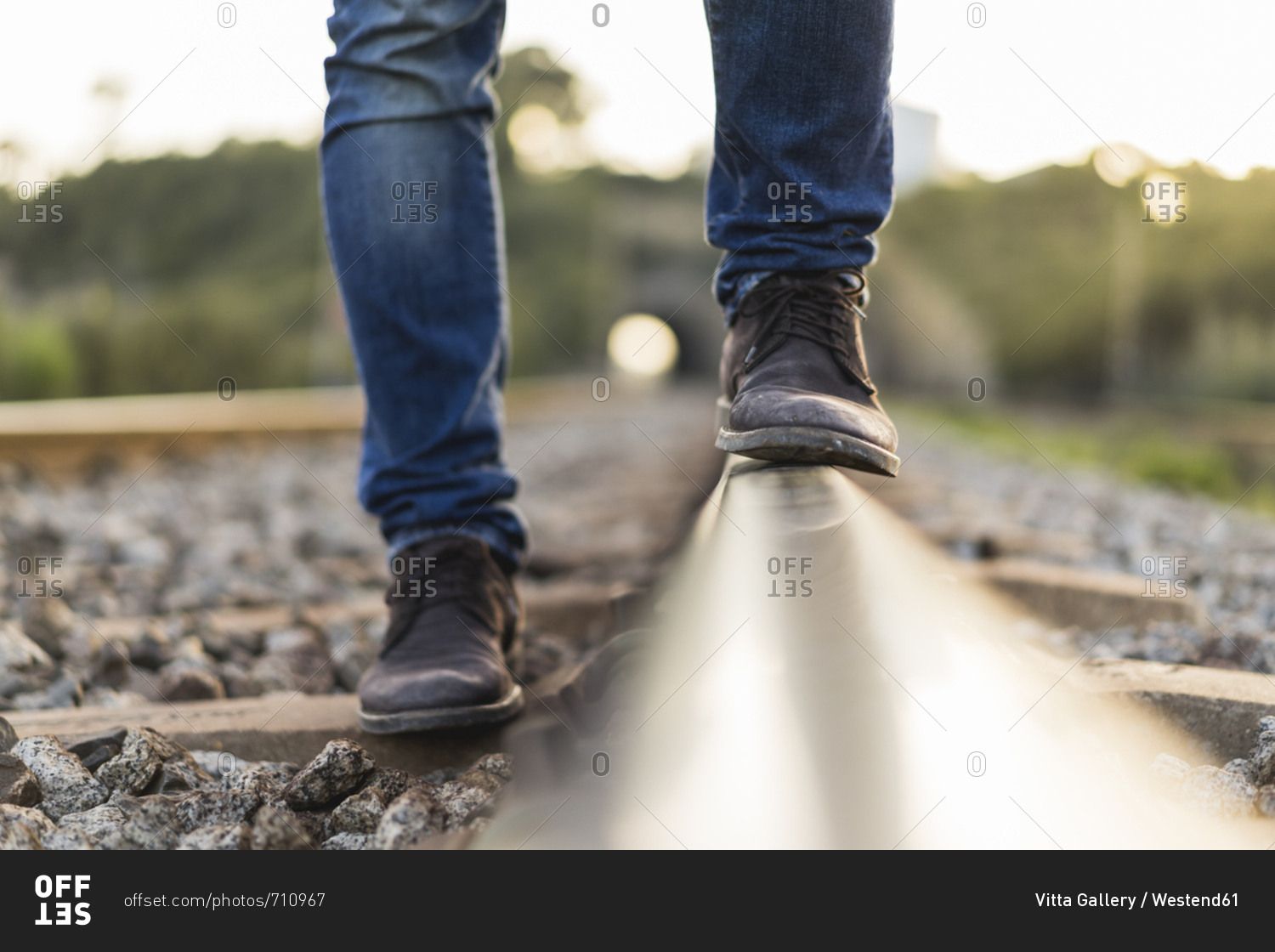 Young man standing on railroad track