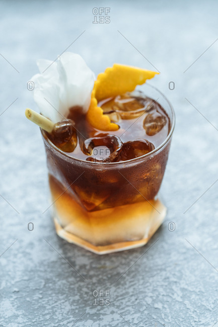 Refreshing alcoholic beverage with orange rind
