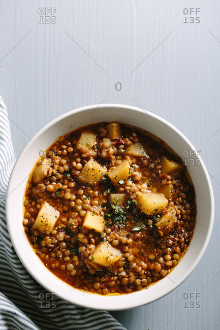 Top down view of hearty lentil soup with potatoes