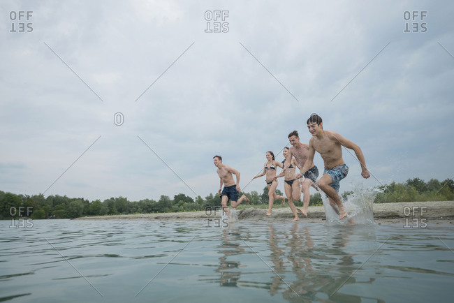 Youths while bathing in the lake, quarry pond Liedolsheim, Dettenheim, Baden-Wurttemberg, Germany