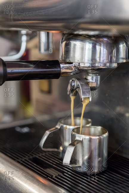 Espresso is poured from espresso machine, close up, in the unpackaged Stuckgut shop, Altona, Hamburg, Germany