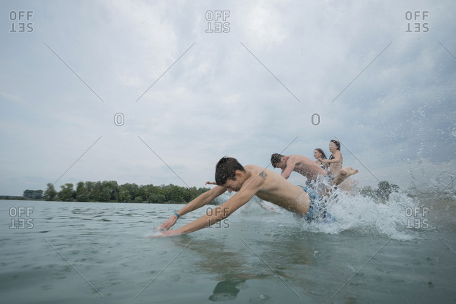 Youths while bathing in the lake, quarry pond Liedolsheim, Dettenheim, Baden-Wurttemberg, Germany