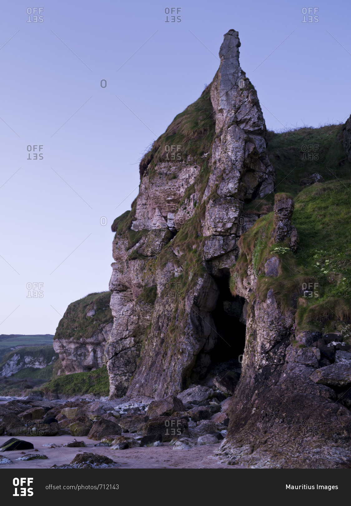 Northern Ireland, Antrim, Causeway Coast, steep coast made of mussel limestone close Ballintoy, crag, sea cave, blue hour