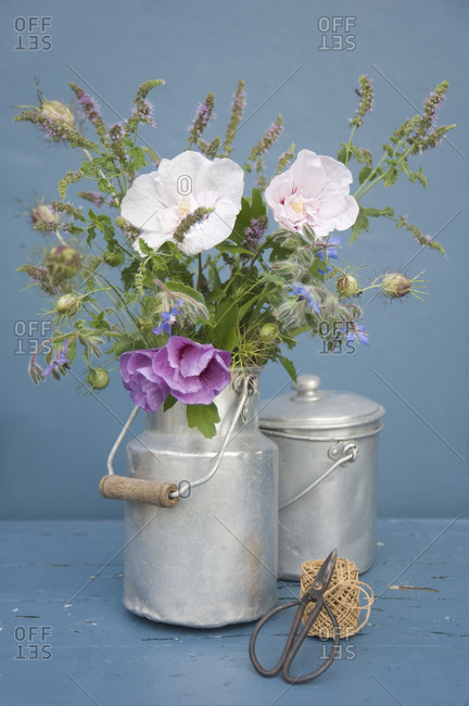 Bouquet with hibiscus in a milk jug