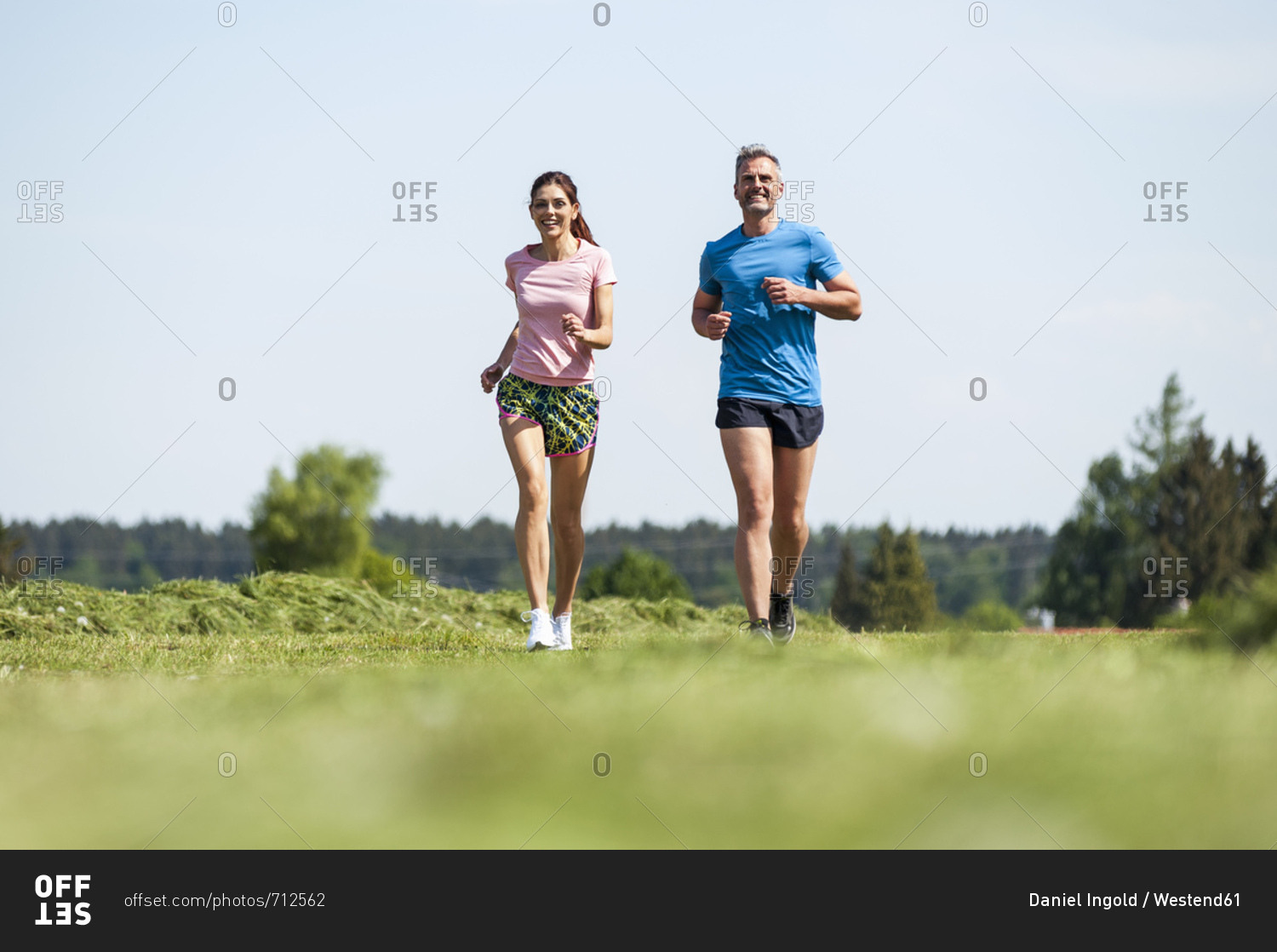 Couple running on field path