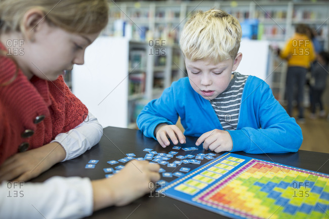 Pupils playing a board game in school library