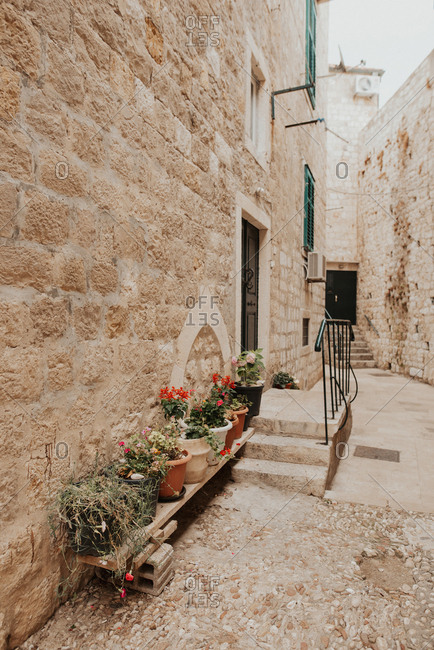 Angled building exterior in sunlit alley