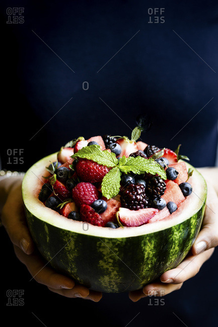 Watermelon fruit bowl held in a womans hands