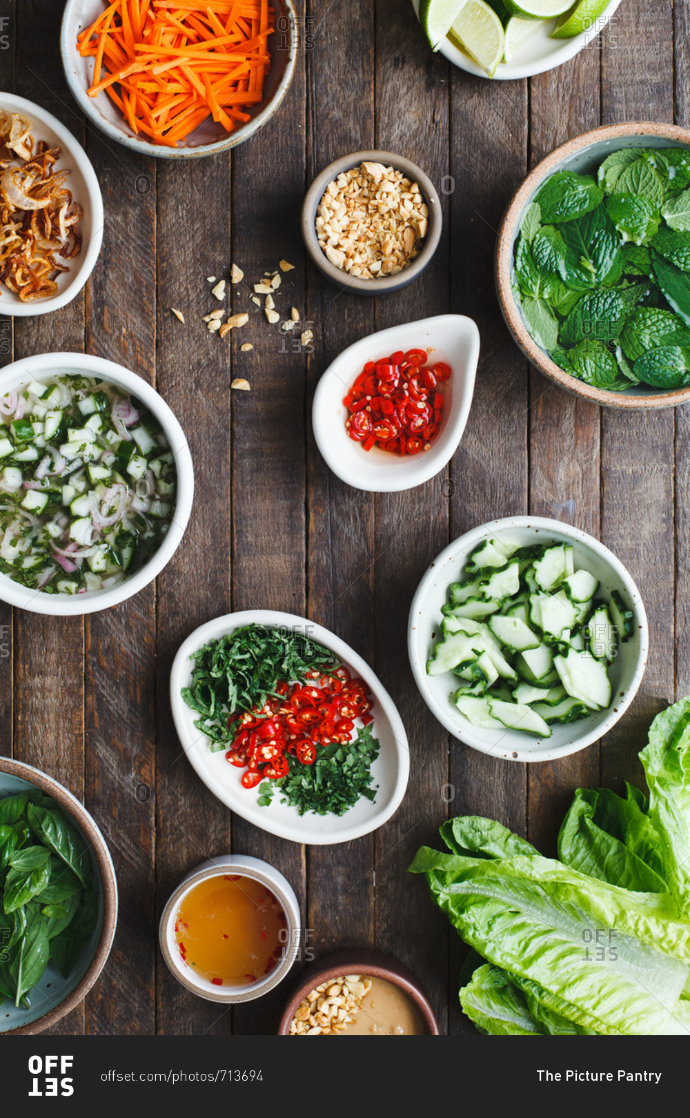 Lettuce cup ingredients in bowls on wood background