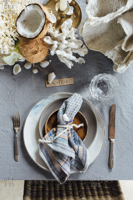 Tropical beach place setting with coral and shells