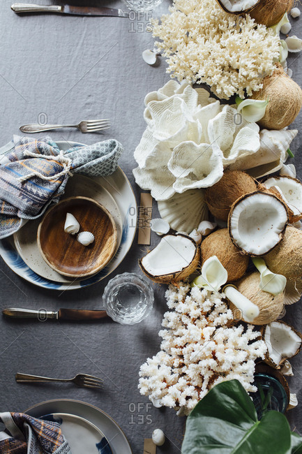 Tropical beach place setting with coral and shells