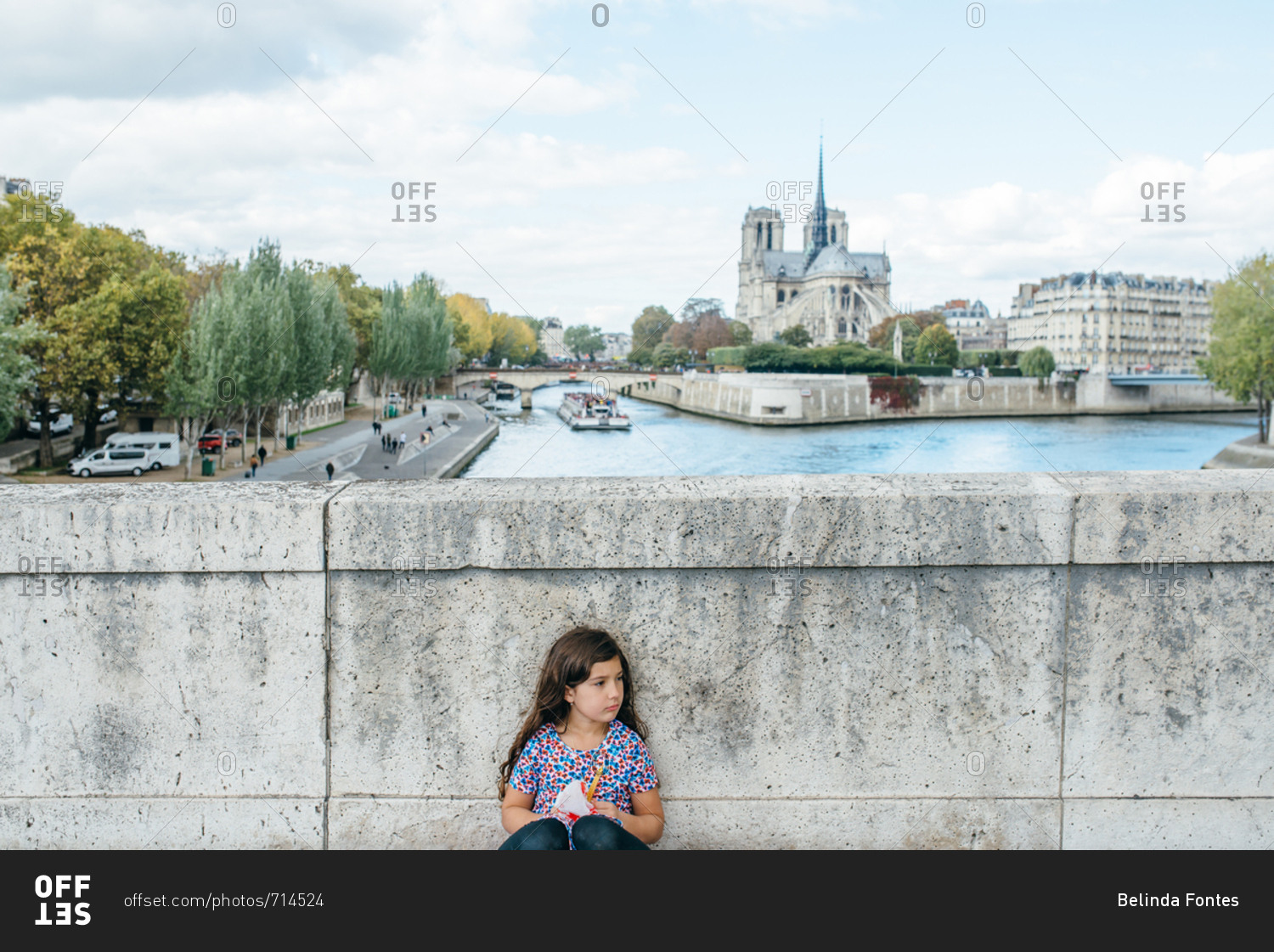 Girl with an Eiffel tower toy on a bridge, Paris