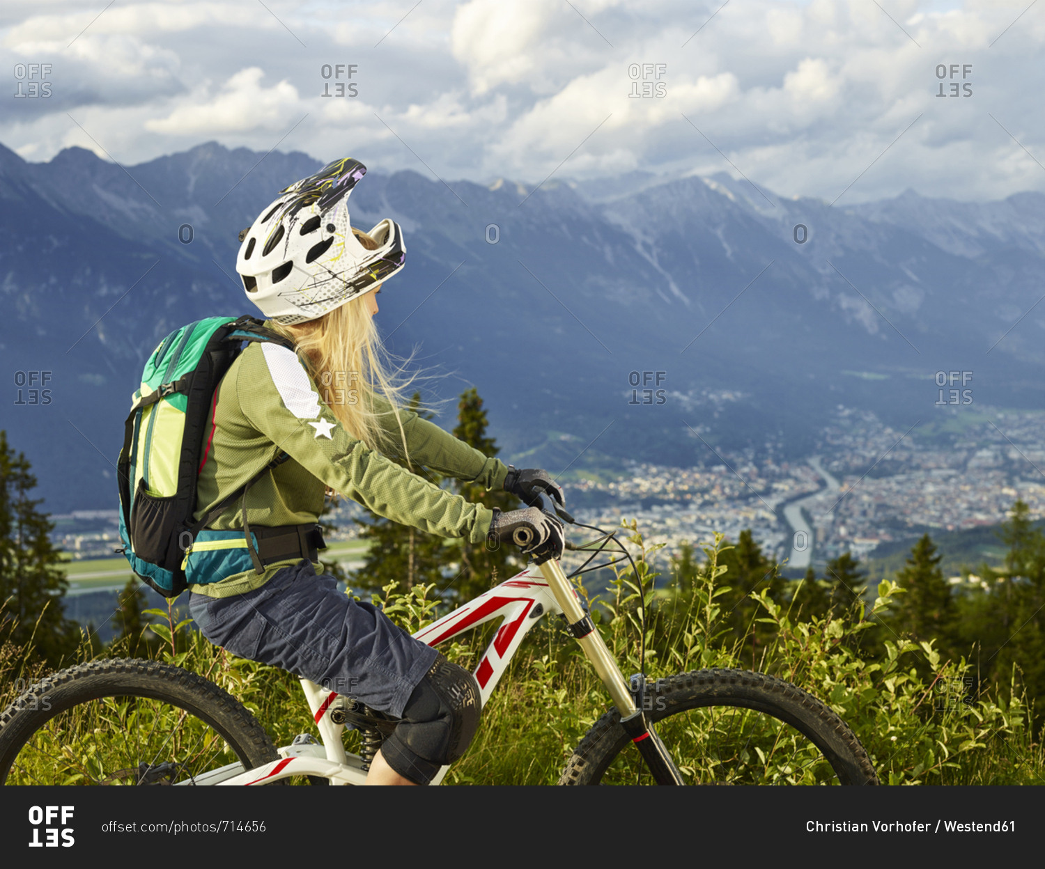 Austria- Tyrol- female downhill mountain biker looking into valley