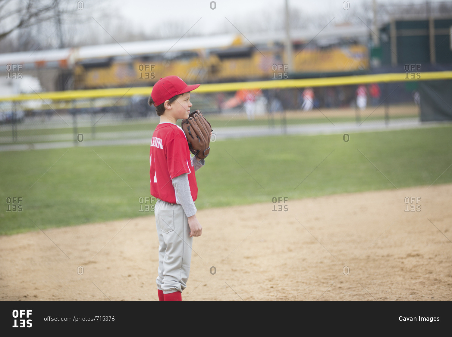 Side view of boy playing baseball at sports field