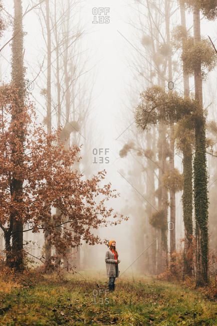 Pretty woman in foggy forest