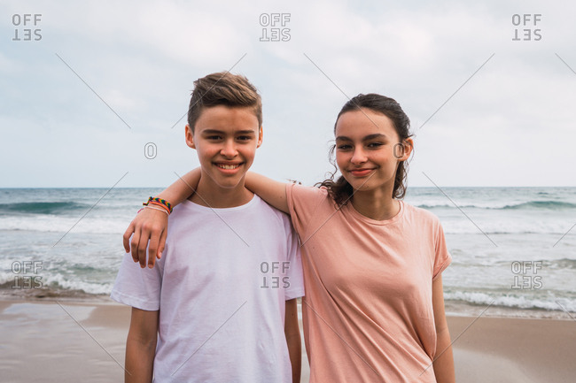 Girl And Boy Standing Next To The Sea In Embrace And Smiling Stock Photo Offset